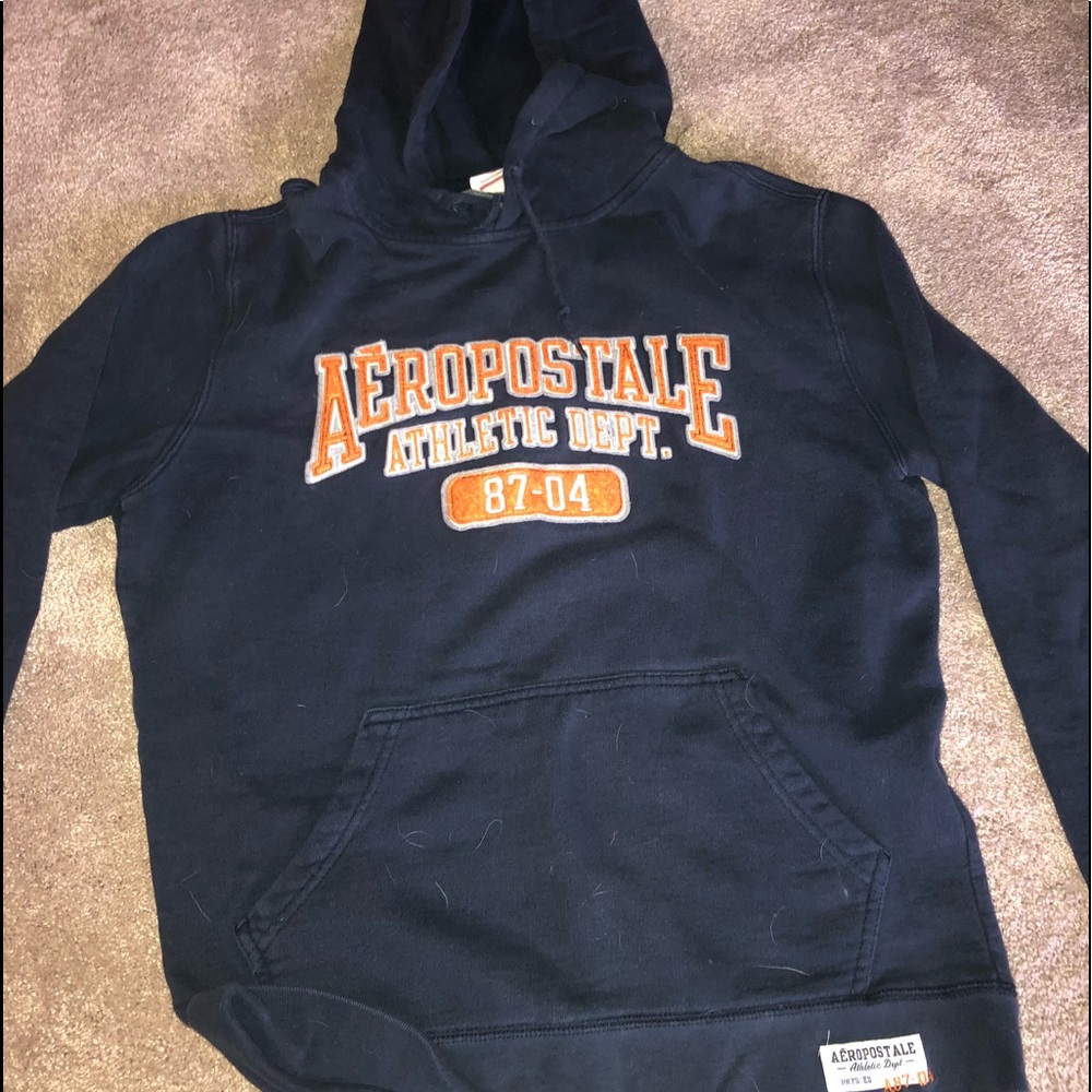 A navy blue sweatshirt with orange branding